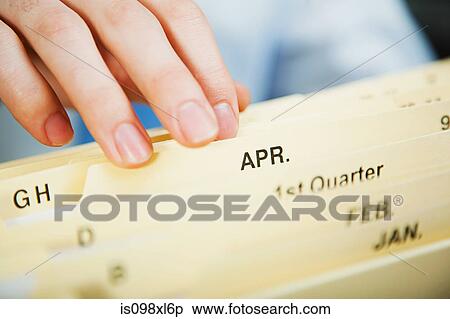 Stock Photography - Office worker filing document. Fotosearch