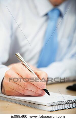 Office worker making notes in notebook View Large Photo Image Stock Image - Office worker making notes in notebook. Fotosearch