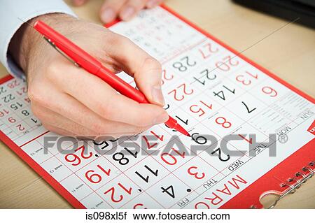 Office worker marking calendar with red pen View Large Photo Image Stock Image - Office worker marking calendar with red pen. Fotosearch