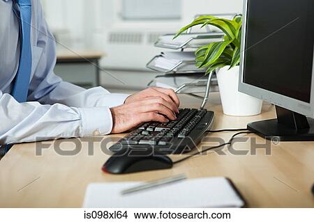 Office worker using computer View Large Photo Image Picture - Office worker using computer. Fotosearch