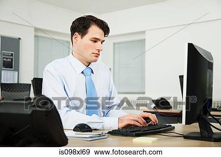 Stock Photo - Office worker using computer. Fotosearch