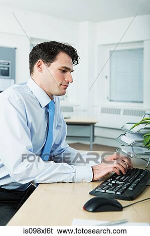 Stock Photograph - Office worker using computer. Fotosearch