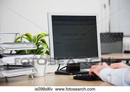 Office worker using computer to update resume View Large Photo Image Stock Photo - Office worker using computer to update resume. Fotosearch