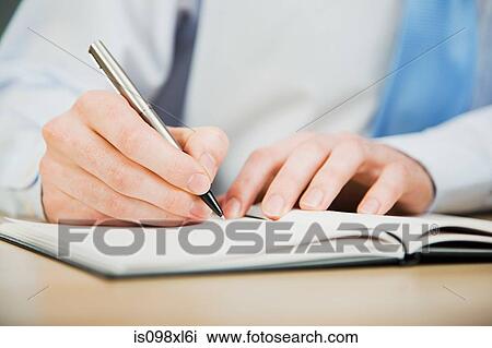 Office worker writing in diary View Large Photo Image Stock Image - Office worker writing in diary. Fotosearch