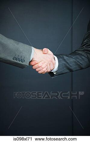 Two businessmen shaking hands View Large Photo Image Stock Image - Two businessmen shaking hands. Fotosearch