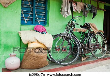 Bicycles and hessian sacks and rags outside village house near Mysore, Karnataka View Large Photo Image Picture - Bicycles and hessian sacks and rags outside village house near Mysore, Karnataka. Fotosearch