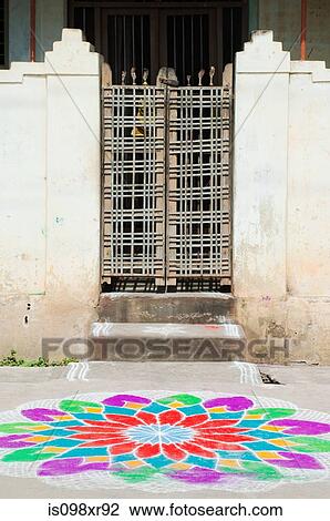 Stock Image - Front gate and colourful chalk flower on street, Trichy, Tamil Nadu. Fotosearch
