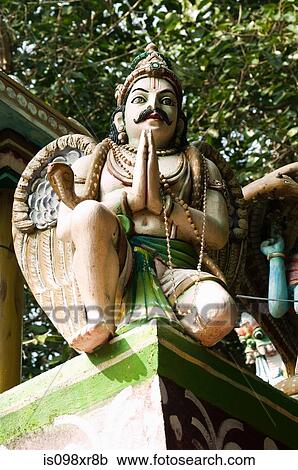 Stock Image - Hindu statue praying, Kerala. Fotosearch