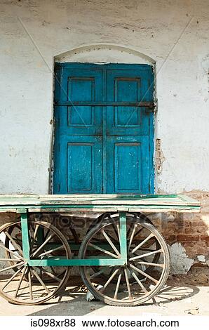 Wooden cart in front of a blue door, Mysore, Karnataka View Large Photo Image Stock Photo - Wooden cart in front of a blue door, Mysore, Karnataka. Fotosearch