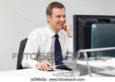 Picture - Businessman using computer. Fotosearch