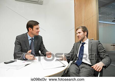 Stock Photo - Businesspeople having duscussion. Fotosearch