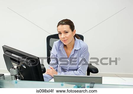 Stock Image - Businesswoman in office. Fotosearch
