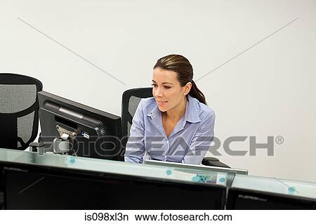 Businesswoman using computer View Large Photo Image Picture - Businesswoman using computer. Fotosearch