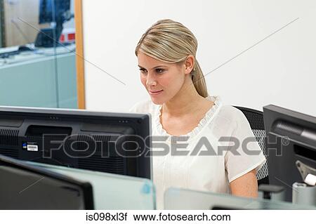 Stock Image - Businesswoman using computer. Fotosearch