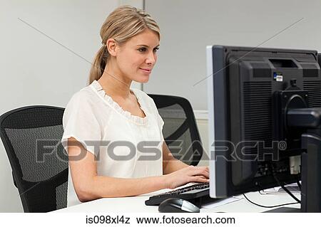 Stock Photo - Businesswoman using computer. Fotosearch