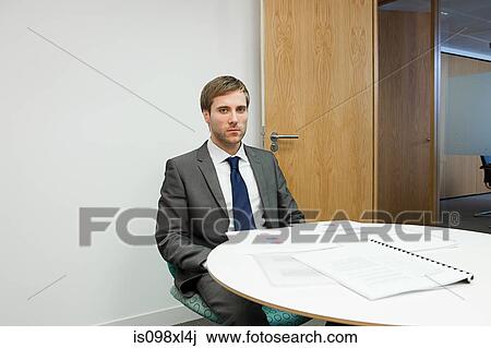 Portrait of businessman at table View Large Photo Image Stock Image - Portrait of businessman at table. Fotosearch