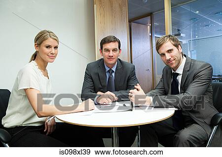 Portrait of businesspeople at table View Large Photo Image Stock Photo - Portrait of businesspeople at table. Fotosearch