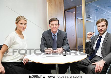 Portrait of businesspeople at table View Large Photo Image Stock Photo - Portrait of businesspeople at table. Fotosearch