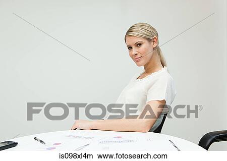 Portrait of businesswoman at table View Large Photo Image Picture - Portrait of businesswoman at table. Fotosearch