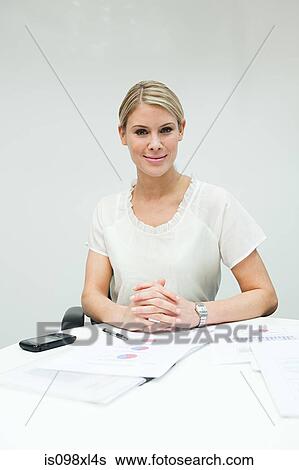 Portrait of businesswoman at table View Large Photo Image Stock Photograph - Portrait of businesswoman at table. Fotosearch