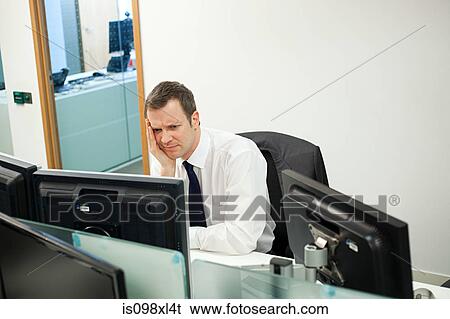 Stock Photograph - Worried businessman in office. Fotosearch