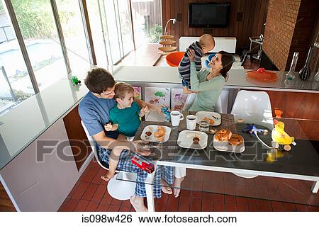 Stock Photograph - Family eating breakfast. Fotosearch