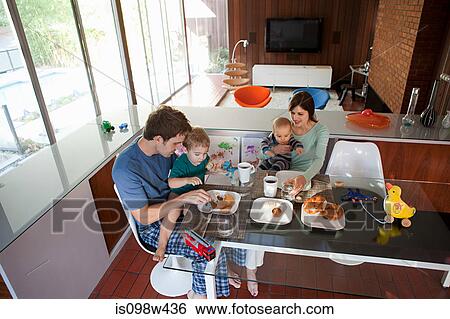 Stock Photograph - Family eating breakfast. Fotosearch