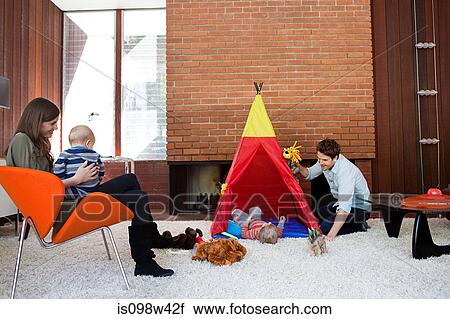 Stock Image - Family playing in living room. Fotosearch