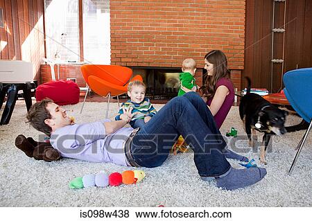 Family playing in living room View Large Photo Image Stock Photo - Family playing in living room. Fotosearch