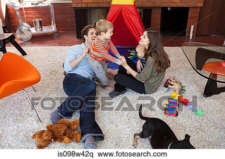 Family playing in living room View Large Photo Image Stock Photography - Family playing in living room. Fotosearch