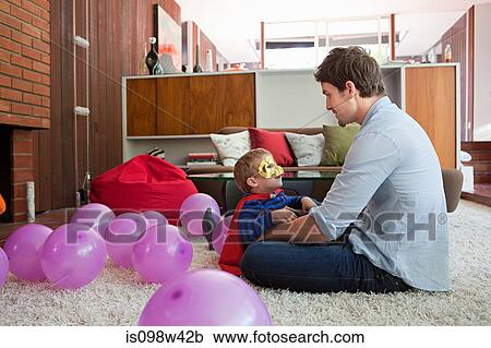 Father and son playing with balloons in living room View Large Photo Image Stock Image - Father and son playing with balloons in living room. Fotosearch