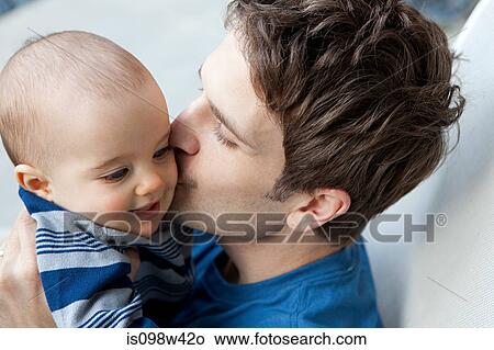 Father kissing baby son on cheek View Large Photo Image Picture - Father kissing baby son on cheek. Fotosearch