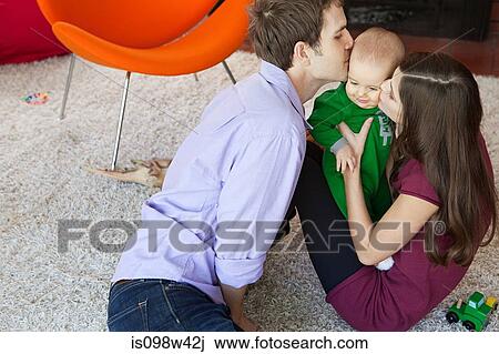Parents with baby son in living room View Large Photo Image Stock Image - Parents with baby son in living room. Fotosearch