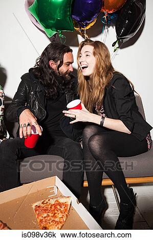 Couple sitting at party View Large Photo Image Stock Image - Couple sitting at party. Fotosearch