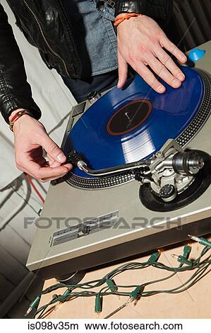Picture - Disc jockey at party on mixing desk. Fotosearch