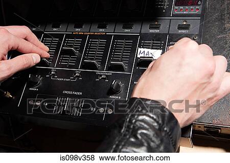 Disc jockey at party on mixing desk View Large Photo Image Stock Photo - Disc jockey at party on mixing desk. Fotosearch