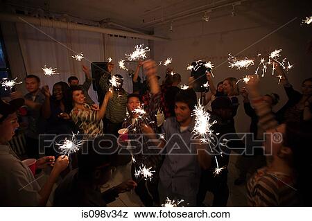 People dancing at party with sparklers View Large Photo Image Stock Photo - People dancing at party with sparklers. Fotosearch