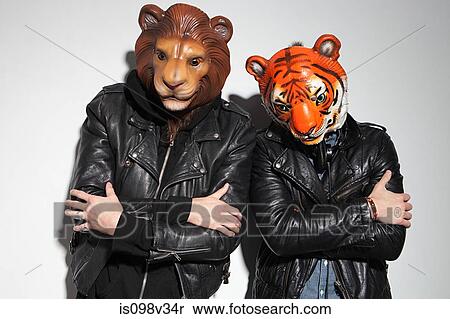 Stock Photography - People wearing lion and tiger masks at party. Fotosearch