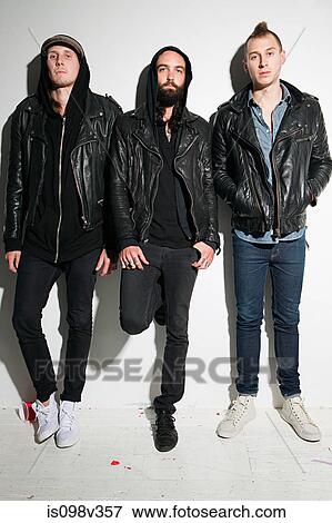 Stock Photo - Three men wearing leather jackets at party. Fotosearch