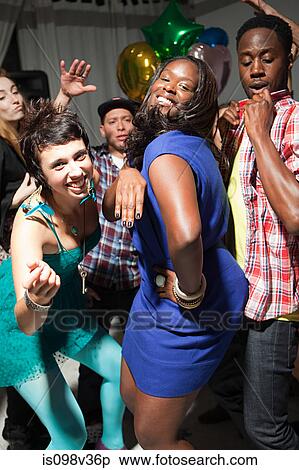Woman wearing blue dress dancing at party View Large Photo Image Stock Photography - Woman wearing blue dress dancing at party. Fotosearch