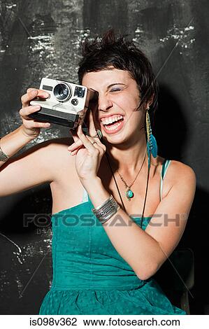 Woman wearing green dress at party taking photograph View Large Photo Image Stock Image - Woman wearing green dress at party taking photograph. Fotosearch