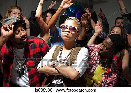 Stock Image - Woman wearing sunglasses at party. Fotosearch