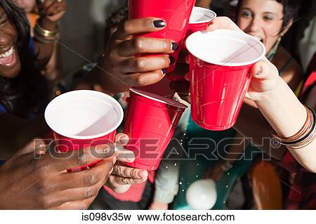 Young people with plastic cups at party View Large Photo Image Stock Photo - Young people with plastic cups at party. Fotosearch