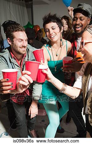 Young people with plastic cups at party View Large Photo Image Stock Photograph - Young people with plastic cups at party. Fotosearch