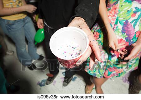 Stock Photography - Young people with plastic cups at party. Fotosearch