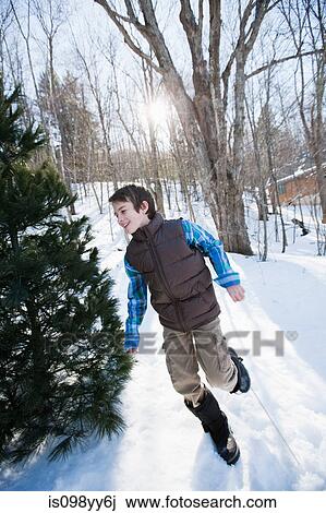 Boy running in snow View Large Photo Image Stock Image - Boy running in snow. Fotosearch