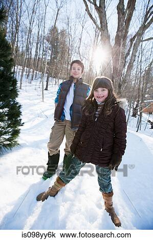 Brother and sister standing in snow, portrait View Large Photo Image Stock Image - Brother and sister standing in snow, portrait. Fotosearch