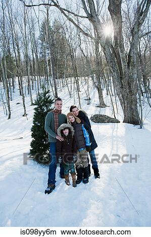 Family standing in snow, portrait View Large Photo Image Picture - Family standing in snow, portrait. Fotosearch