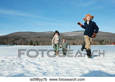 Family walking in snow View Large Photo Image Stock Image - Family walking in snow. Fotosearch
