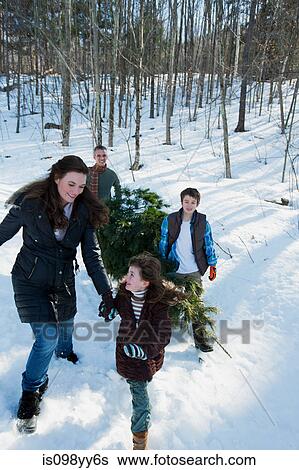 Stock Photograph - Family walking in snow. Fotosearch